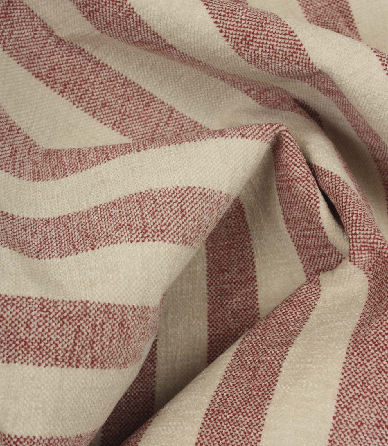 Draped Burleigh Stripe Rose striped upholstery fabric showing its soft velour-inspired texture, elegant stripe pattern and natural movement.