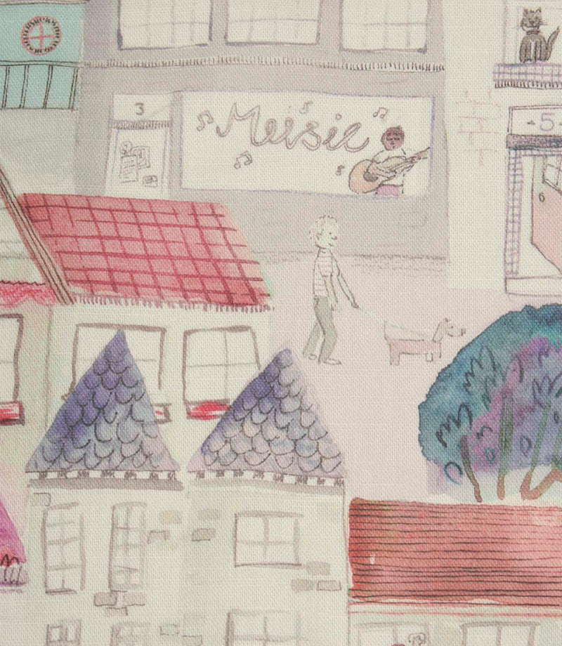 Close-up of Cakes & More cotton fabric showing hand-drawn houses, shops and detailed street scene artwork in purple and pink.