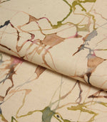 Folded Carrara fabric displaying the natural cotton linen texture and flowing abstract design in green, pink, blue and beige tones.