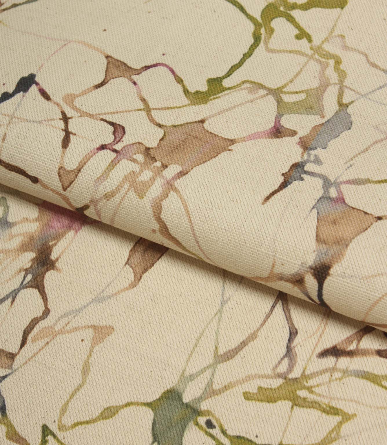 Folded Carrara fabric displaying the natural cotton linen texture and flowing abstract design in green, pink, blue and beige tones.