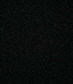 Close-up of Case Bouclé Noir upholstery fabric in deep black, showing its dense looped bouclé weave and richly textured surface.