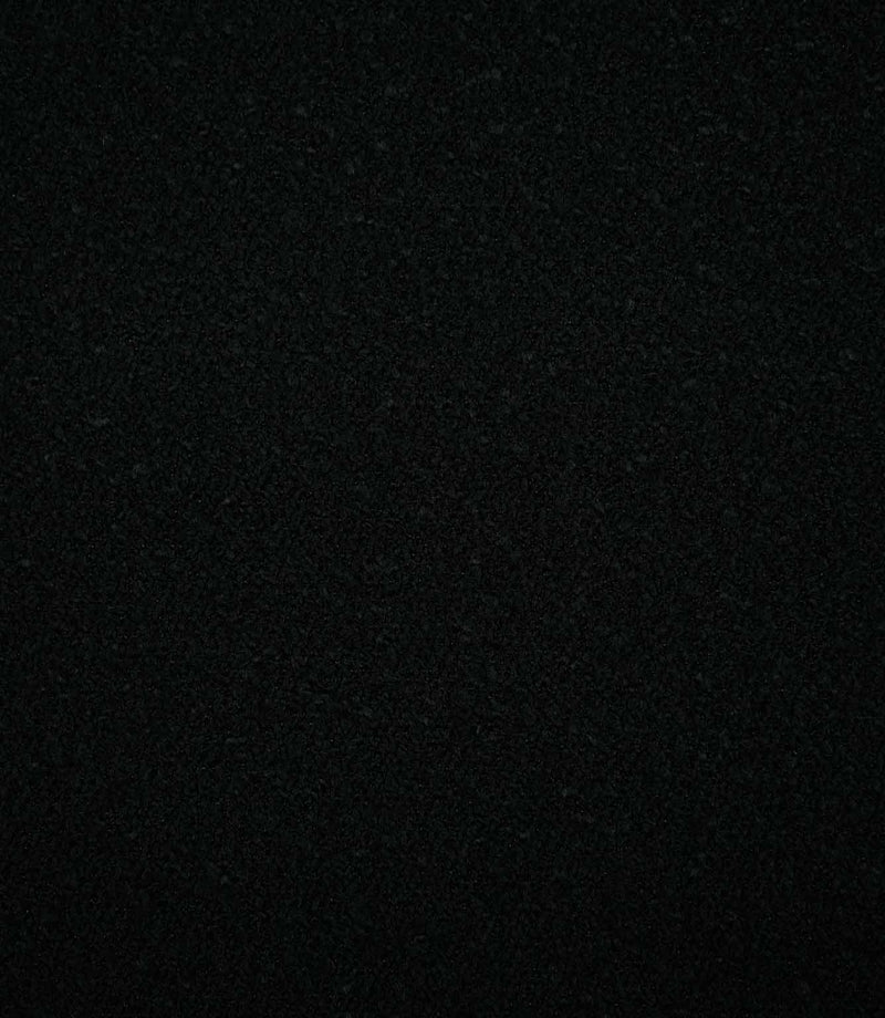 Full-frame view of Case Bouclé Noir black upholstery fabric, highlighting the plain design and soft, tightly woven bouclé texture.