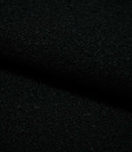 Close-up of folded Case Bouclé Noir fabric, showing the depth and tactile texture of the black bouclé upholstery material.