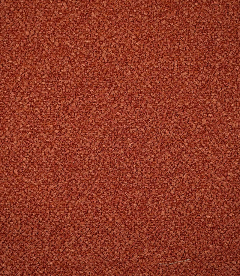 Full-frame view of Case Bouclé terracotta upholstery fabric, highlighting the plain design, warm earthy tone and tactile looped surface.