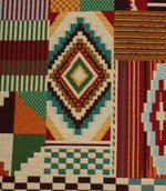 Close-up of vibrant geometric woven fabric showcasing intricate Aztec-style diamond patterns, stripes, and textured tapestry weave detail.