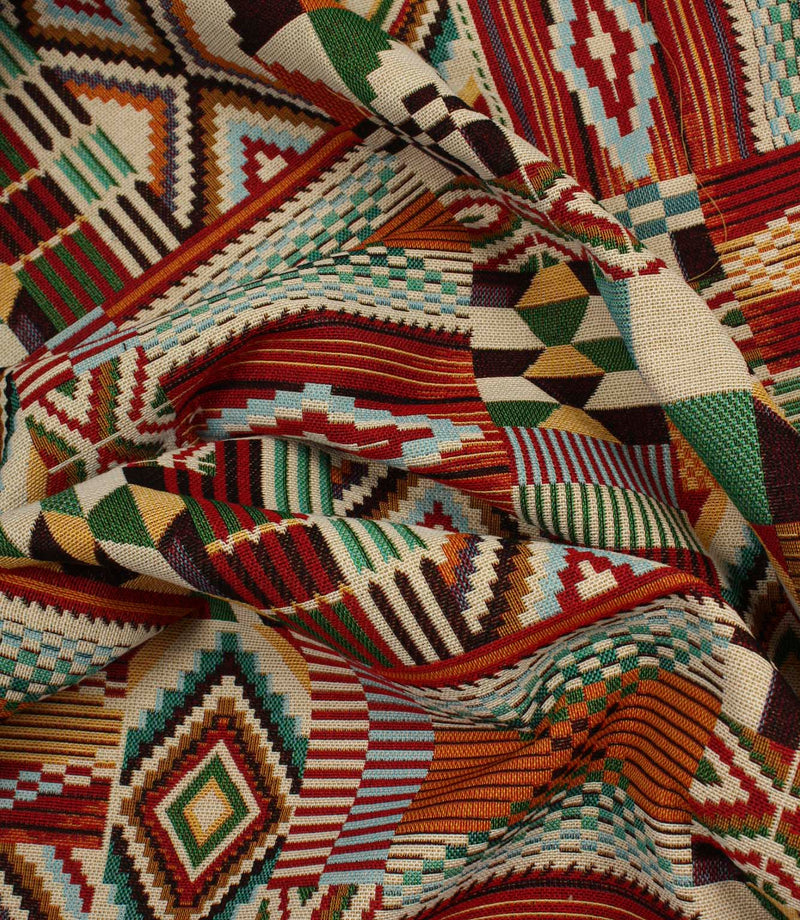 Softly gathered multicoloured geometric fabric showing the detailed woven texture, vibrant patchwork motifs, and tapestry-style finish.