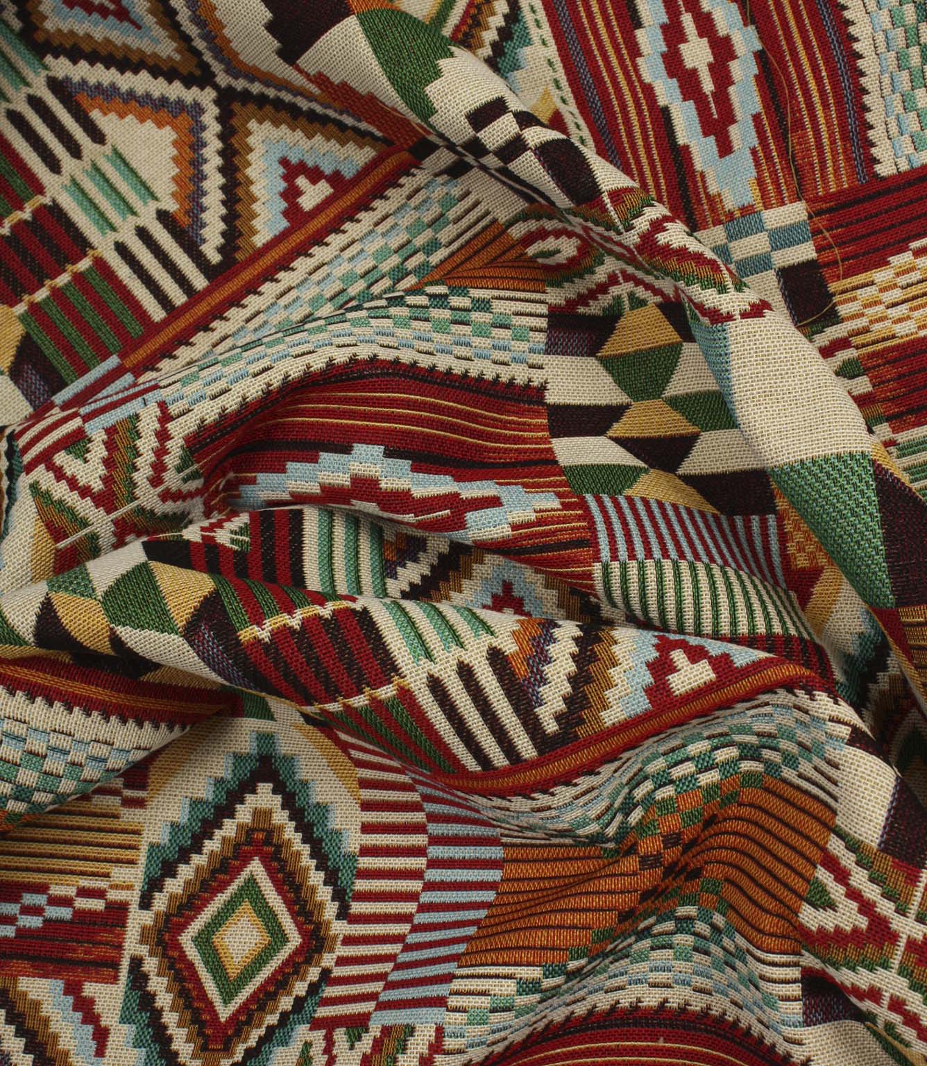 Softly gathered multicoloured geometric fabric showing the detailed woven texture, vibrant patchwork motifs, and tapestry-style finish.
