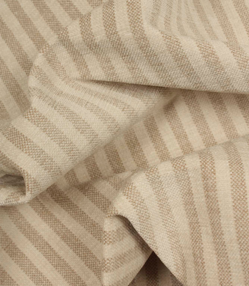 Draped Cavendish Stripe Pebble striped upholstery fabric showing its soft handle, gentle movement and classic pebble beige stripe design.