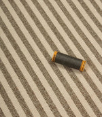 Cavendish Stripe Slate upholstery fire retardant fabric with coordinating slate grey thread, highlighting the fine stripe pattern and durable woven construction.