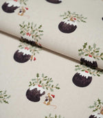 Folded Christmas Pudding Neutral fabric displaying the repeating Christmas pudding design with green holly, red berries and small mice wearing red festive hats.