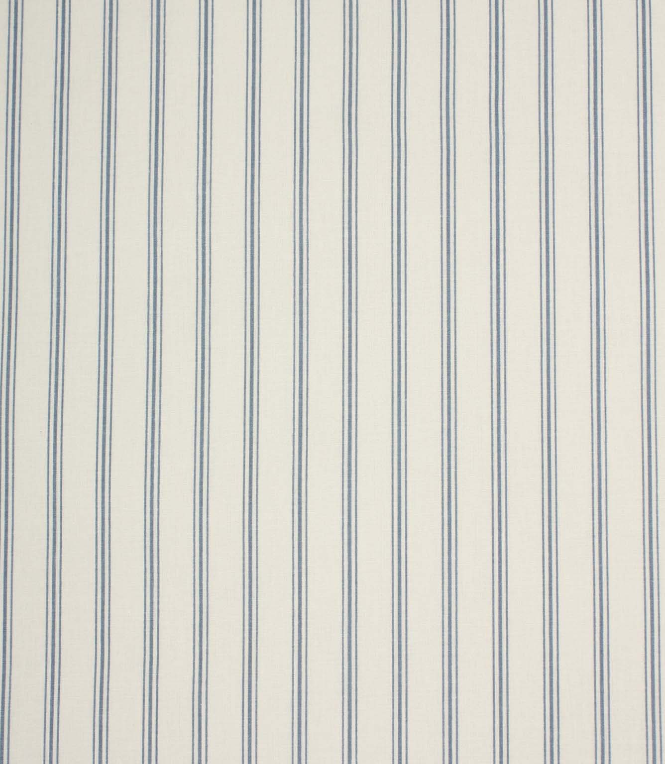 Repeating blue stripe upholstery fabric featuring fine vertical ticking stripes on a warm neutral woven base.