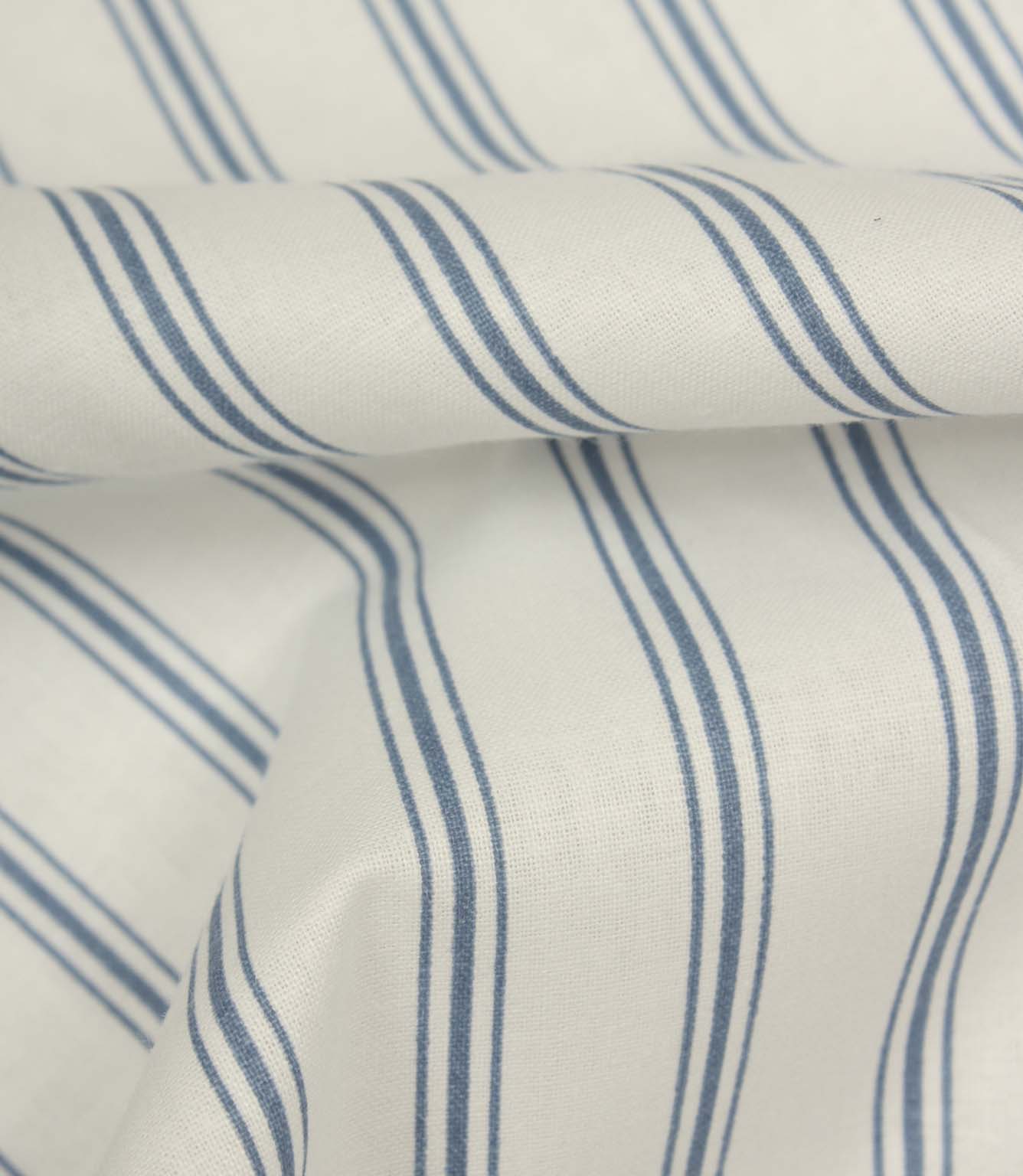 Folded blue ticking stripe fabric highlighting the smooth woven texture and classic narrow stripe detailing.