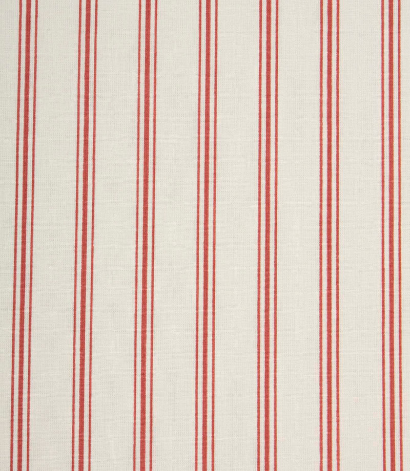 Close-up of ivory and red striped fabric showcasing the subtle woven texture and traditional ticking stripe pattern.