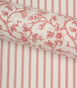 Red ticking stripe fabric paired with a coordinating floral fabric roll, styled to showcase complementary country-inspired designs.