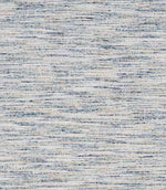 Close-up of woven upholstery fabric in soft neutral tones with subtle blue flecks and a horizontal textured weave.