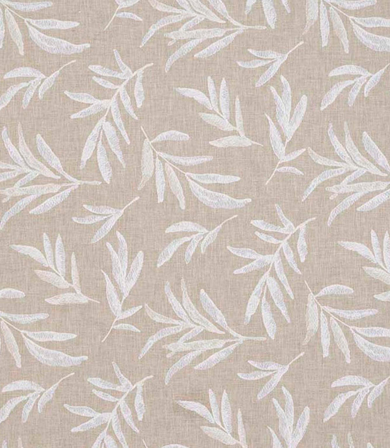 Close-up of floral embroidered fabric showing delicate leaf motifs stitched across a textured neutral base.