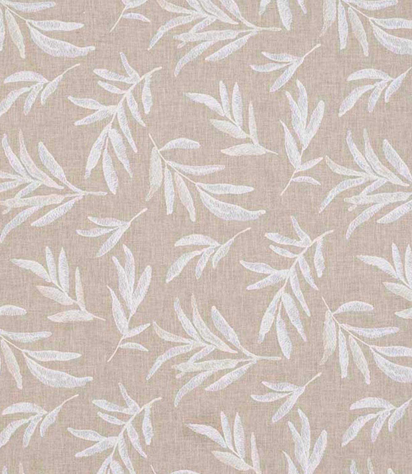 Close-up of floral embroidered fabric showing delicate leaf motifs stitched across a textured neutral base.