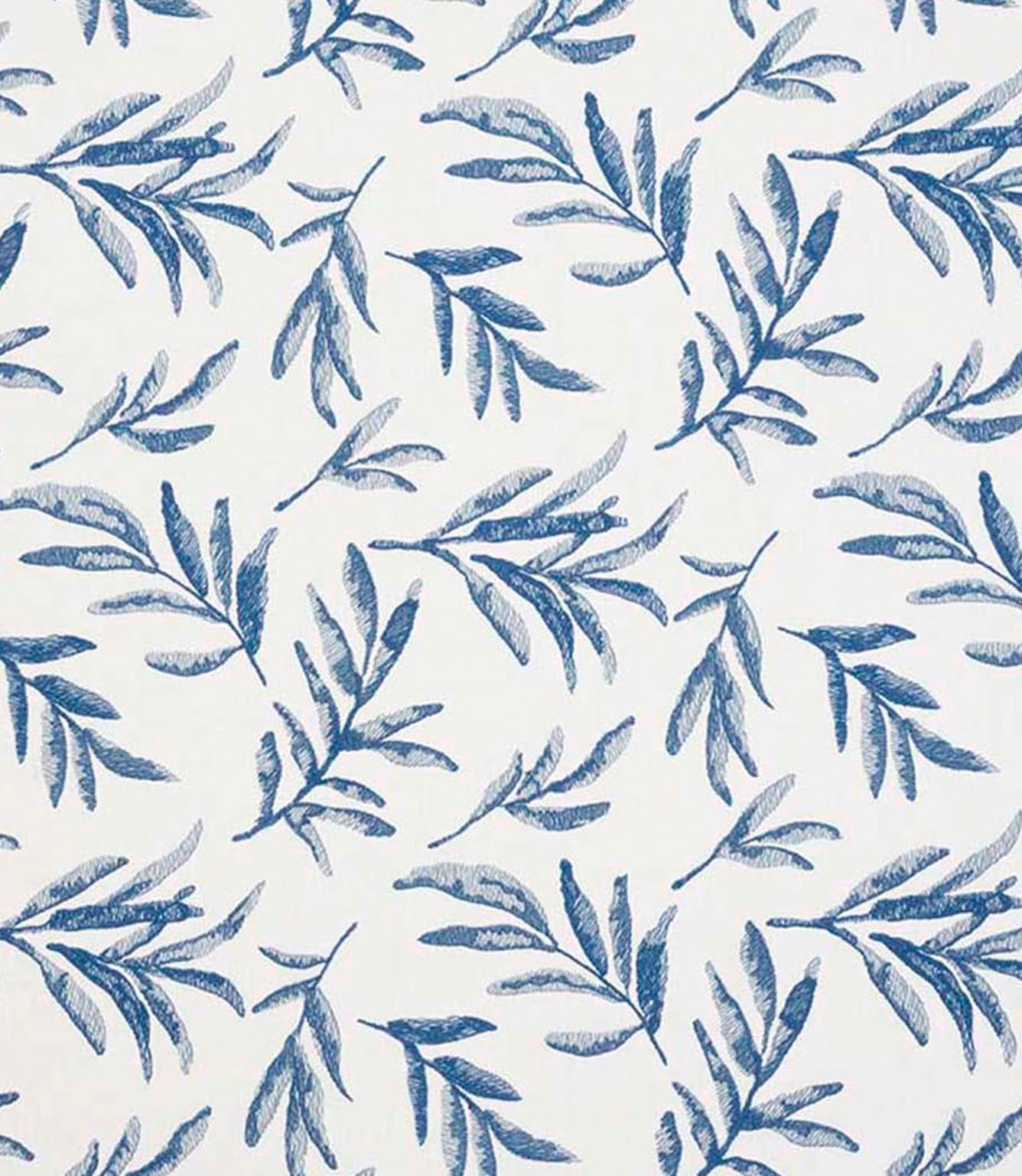 Close-up of embroidered floral upholstery fabric showing detailed leaf motifs in layered blue tones on a neutral base.