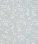 Close-up of embroidered floral upholstery fabric showing delicate leaf motifs in pale blue tones on a softly textured base.