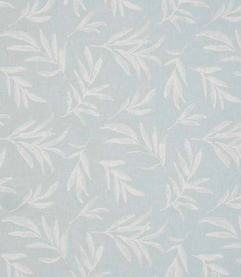 Close-up of embroidered floral upholstery fabric showing delicate leaf motifs in pale blue tones on a softly textured base.