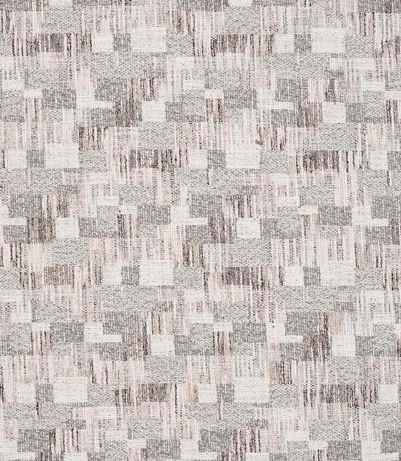 Close-up of woven geometric fabric with an abstract check pattern in soft grey, beige and off-white tones, featuring a textured, layered weave.