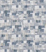 Close-up of woven geometric fabric with an abstract check pattern in soft blue, grey and off-white tones, featuring a textured, layered weave.
