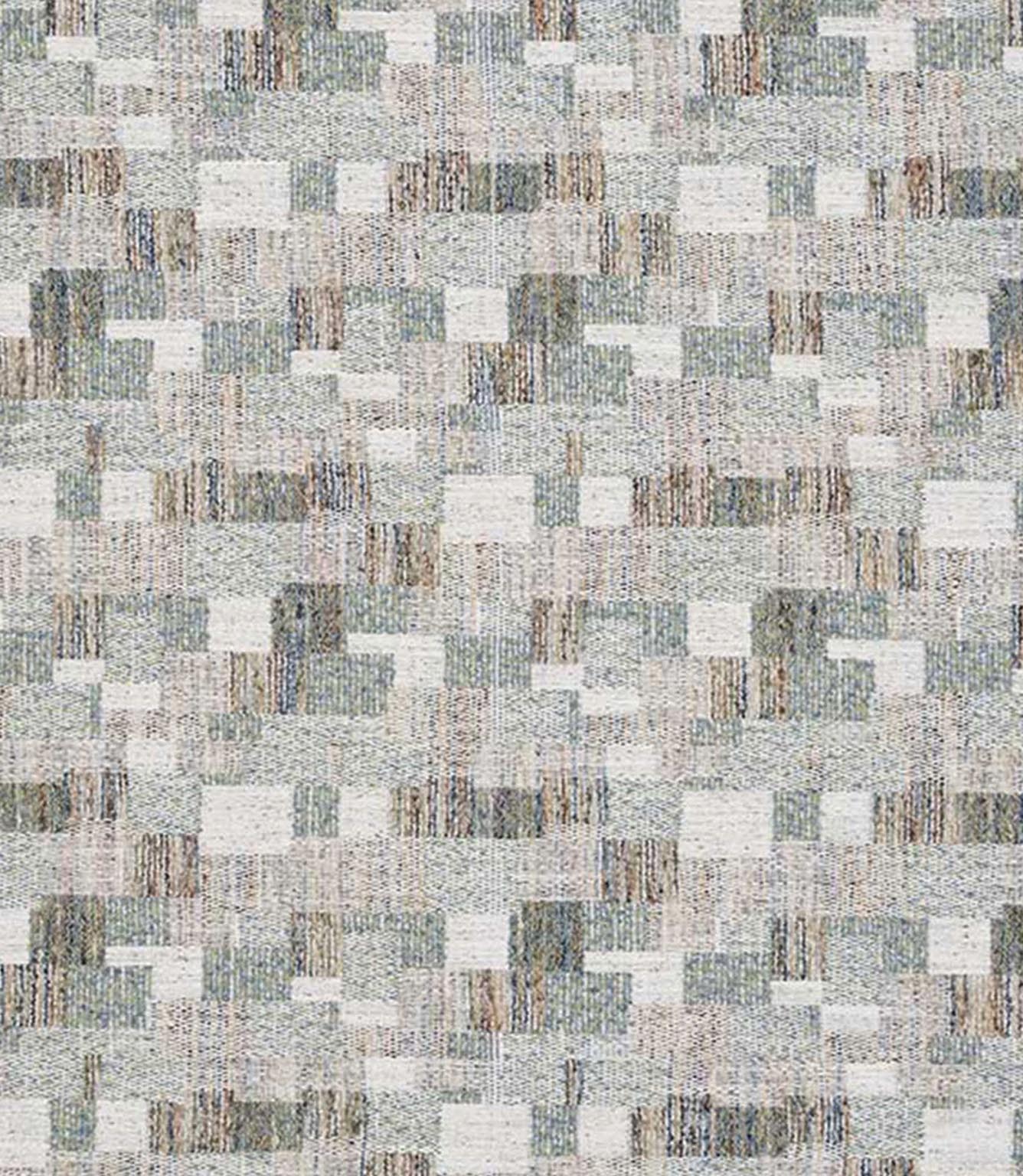 Close-up of woven geometric fabric with an abstract check pattern in soft sage green, muted blue and warm neutral tones, showing a textured, layered weave.