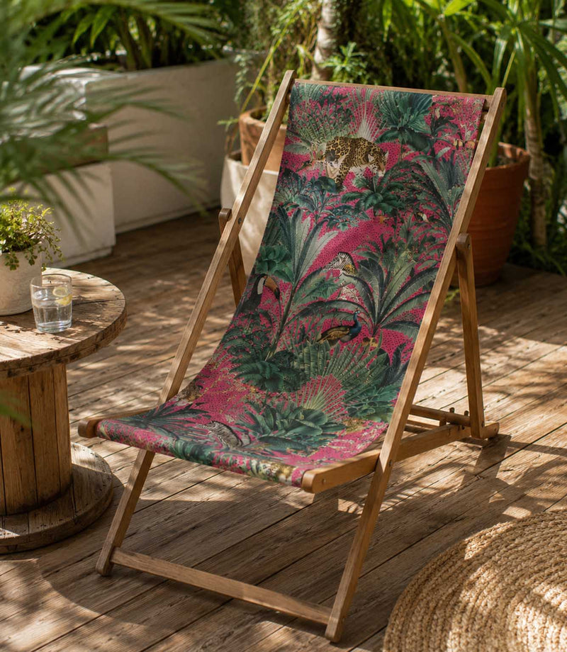 Jungle animal and foliage patterned fabric on an deckchair in a tropical outdoor garden setting