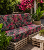 Jungle animal and foliage patterned fabric on an outdoor sofa in a tropical garden setting