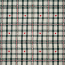 Cotswold Heart Tartan fabric in ivory and dark green, featuring a classic checked design with small red hearts and decorative red and white woven lines.
