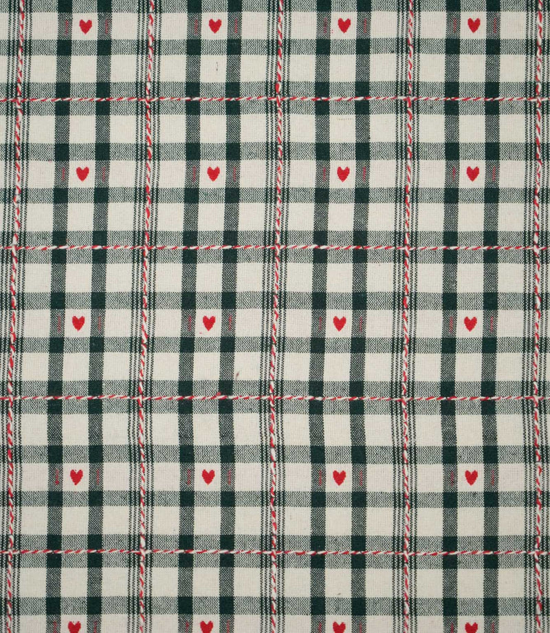 Cotswold Heart Tartan fabric in ivory and dark green, featuring a classic checked design with small red hearts and decorative red and white woven lines.