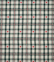 Cotswold Heart Tartan fabric in ivory and dark green, featuring a classic checked design with small red hearts and decorative red and white woven lines.