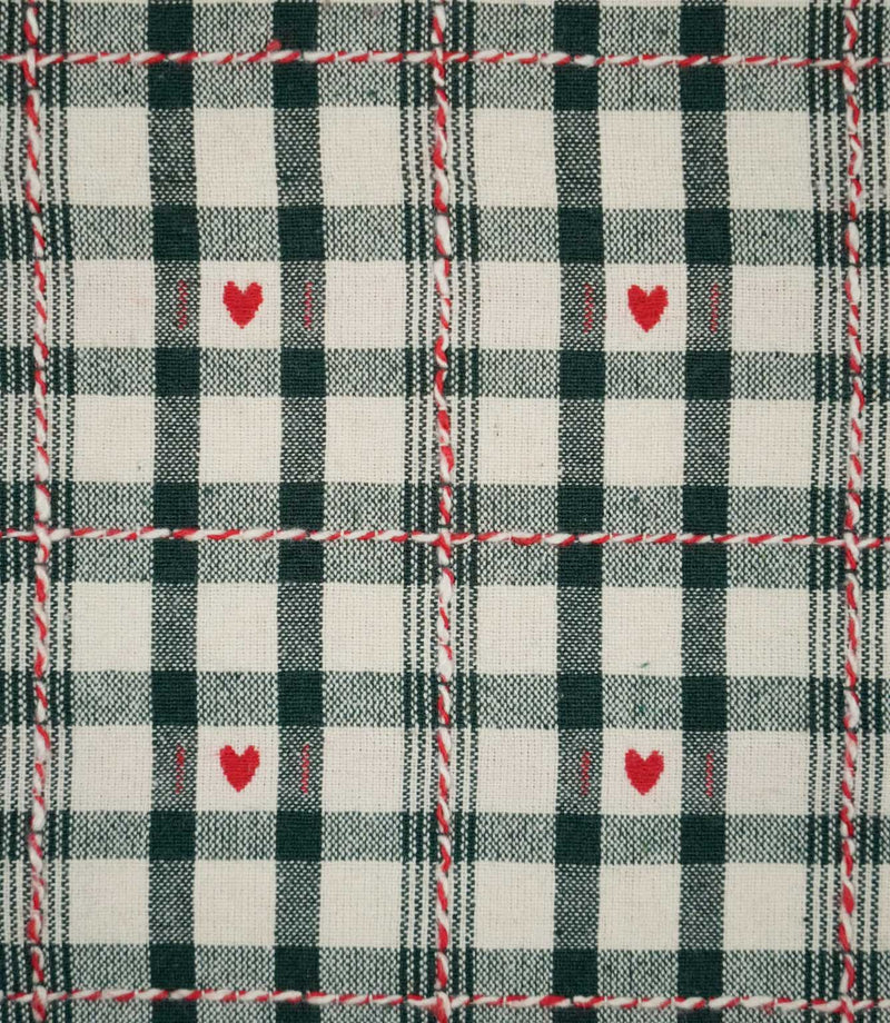 Close-up of Cotswold Heart Tartan ivory and green fabric, showing the woven check pattern, repeating red heart motifs and contrasting decorative thread detail.