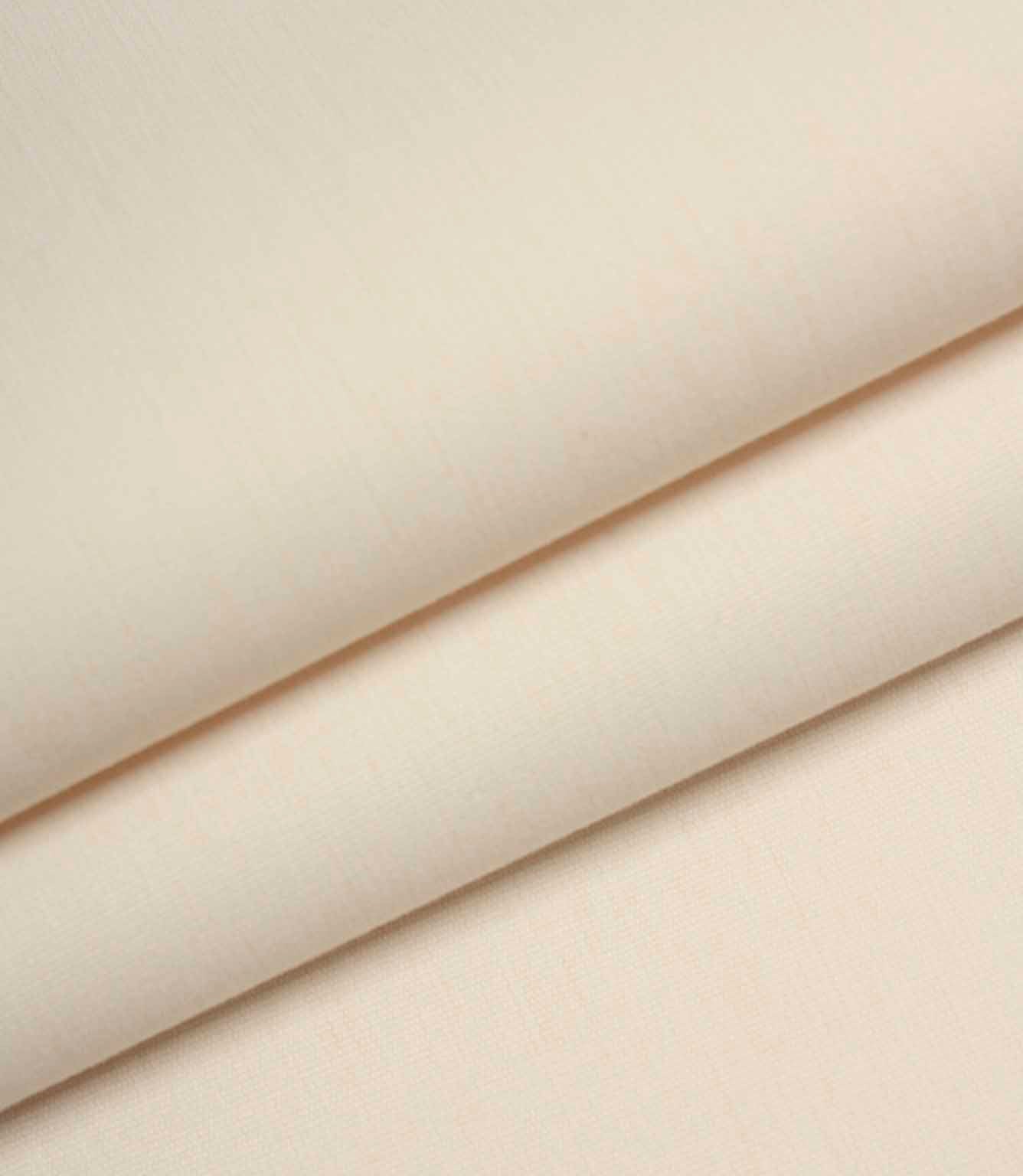Ivory woven fabric folded to show structure, thickness, and smooth surface finish.