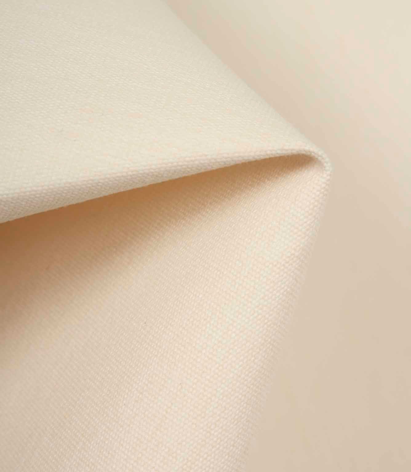 Light cream fabric gently draped to highlight softness, flexibility, and refined texture.