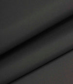 Dark grey woven fabric folded to highlight thickness, structure, and consistent texture.