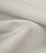 Grey textured fabric draped to highlight softness, movement, and relaxed finish.