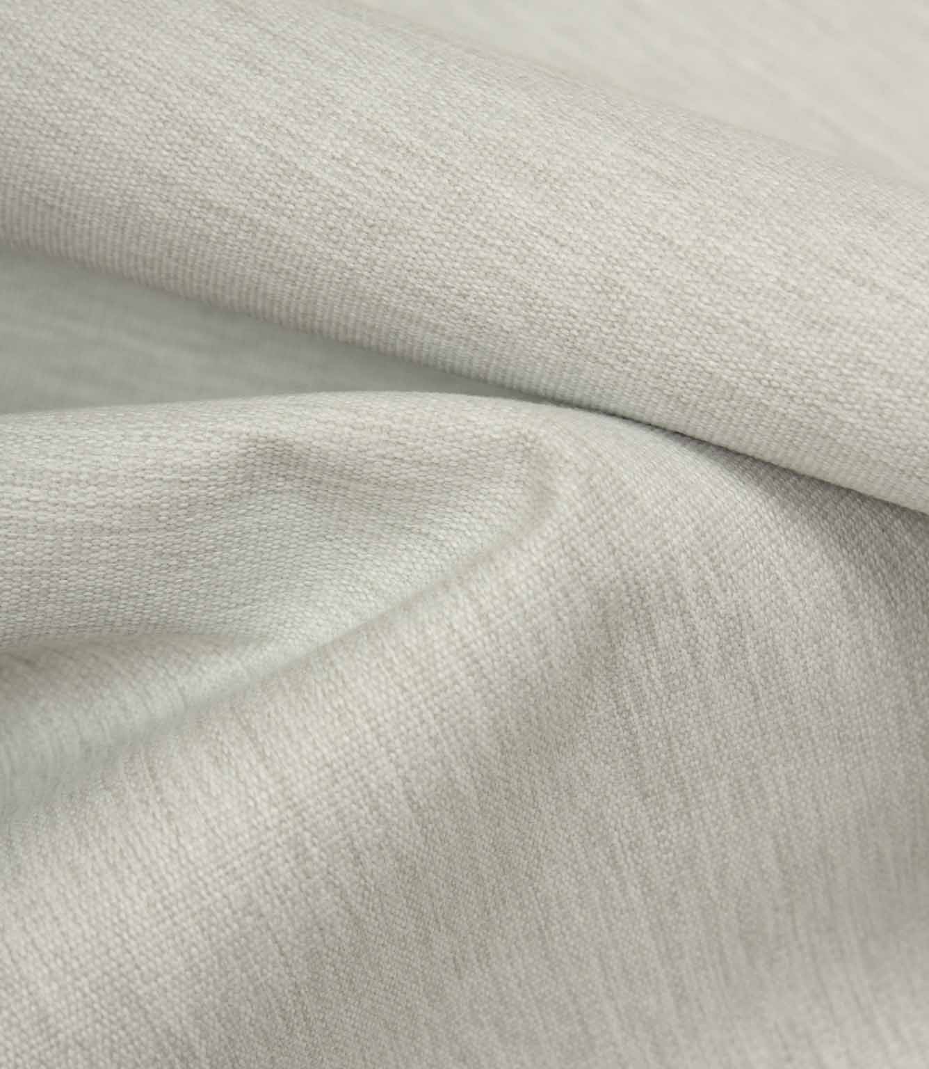 Grey textured fabric draped to highlight softness, movement, and relaxed finish.