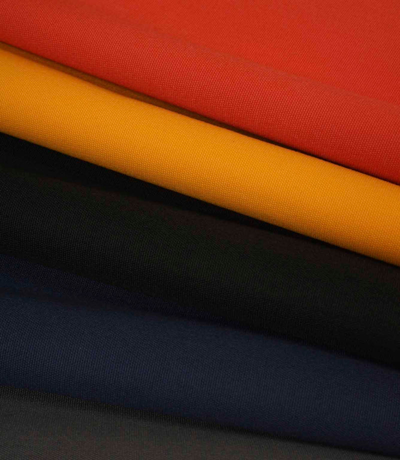 Layered plain weave fabric in red, mustard, black and navy, shown folded to highlight texture and colour contrast.