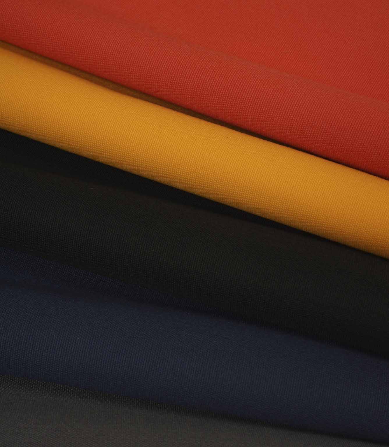 Layered plain weave fabric in red, mustard, black and navy, shown folded to highlight texture and colour contrast.