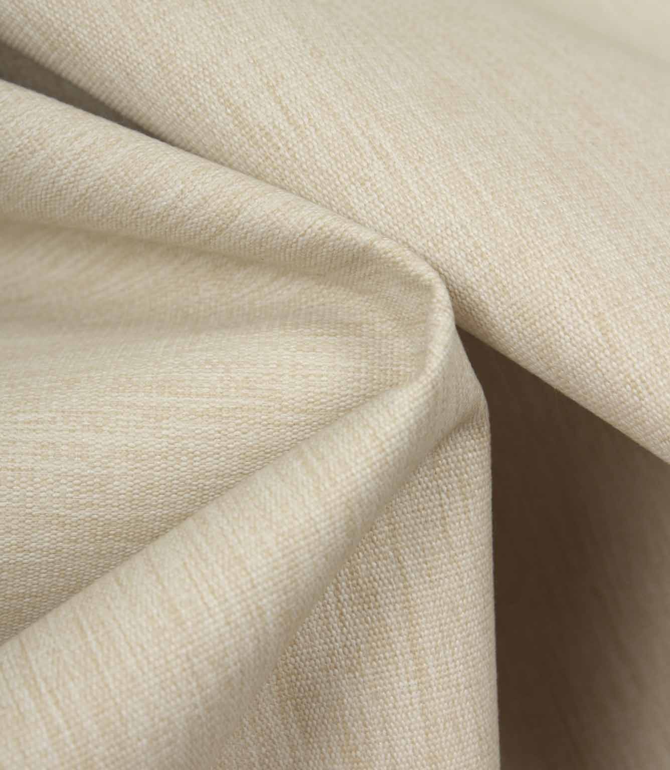 Soft beige fabric draped to highlight movement, texture, and a relaxed, natural finish.