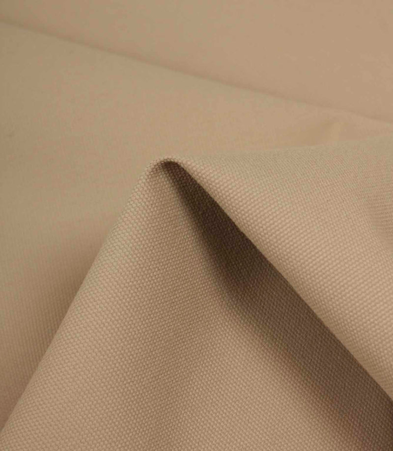 Beige fabric draped over an edge to highlight texture, flexibility, and soft structure.