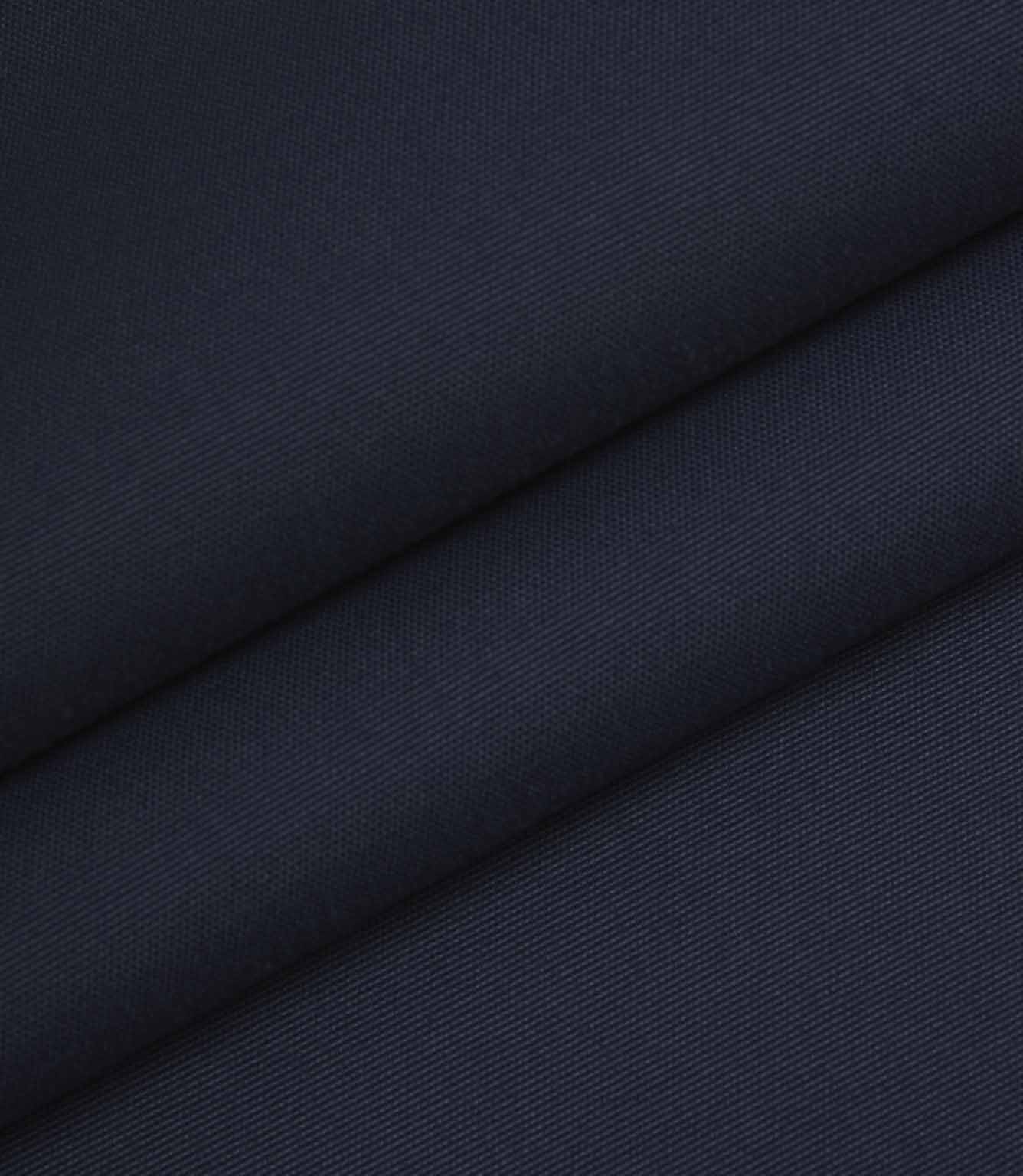 Navy woven fabric folded to highlight structure, density, and surface texture.