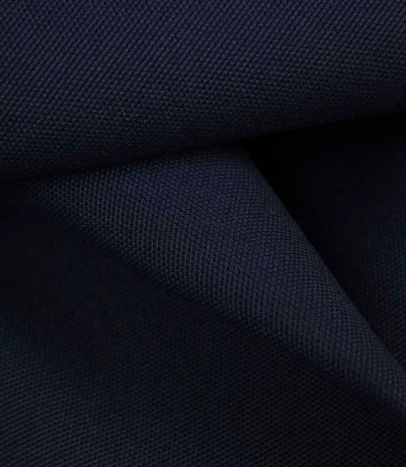 Dark navy fabric draped to show softness, movement, and gentle light reflection across the weave.