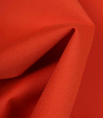 Bright orange fabric draped to show movement, flexibility, and soft structure.