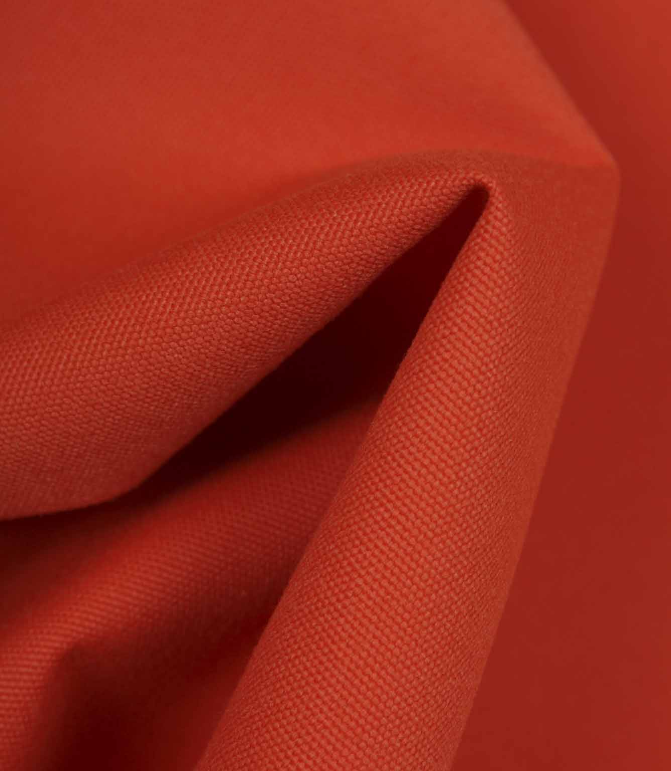 Bright orange fabric draped to show movement, flexibility, and soft structure.