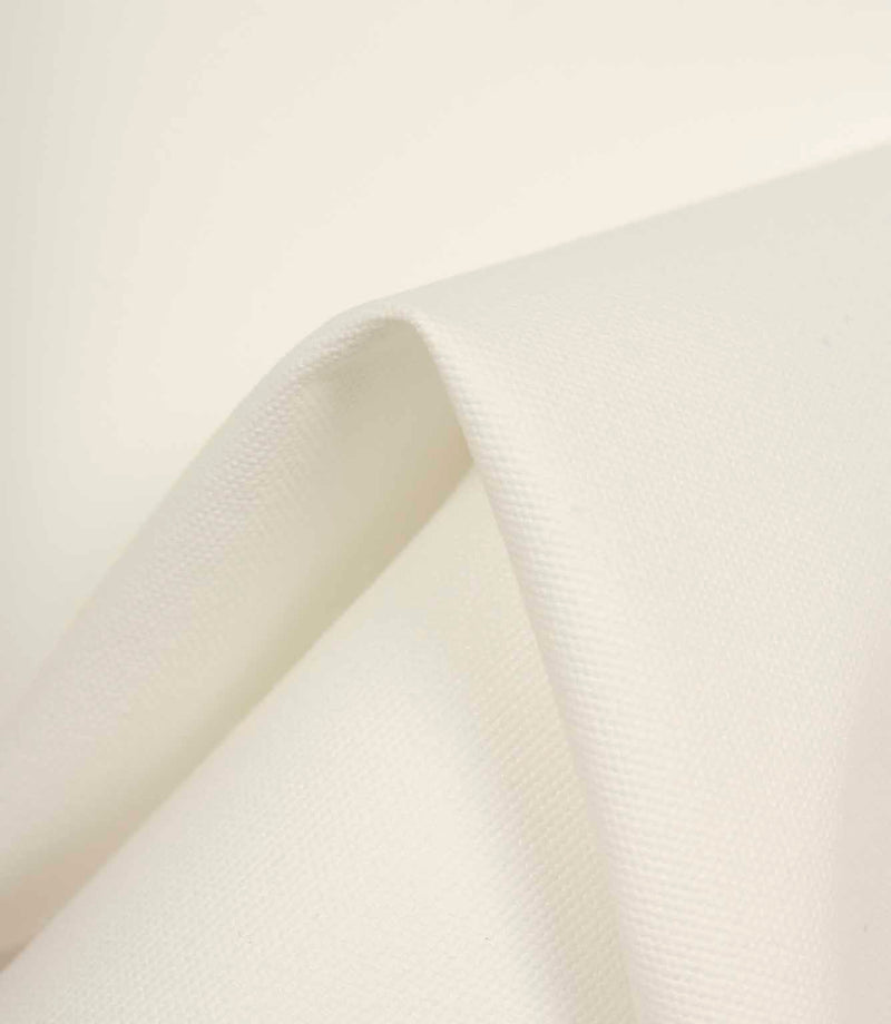 Ivory fabric gently draped to highlight its soft handle, smooth surface, and natural light reflection.
