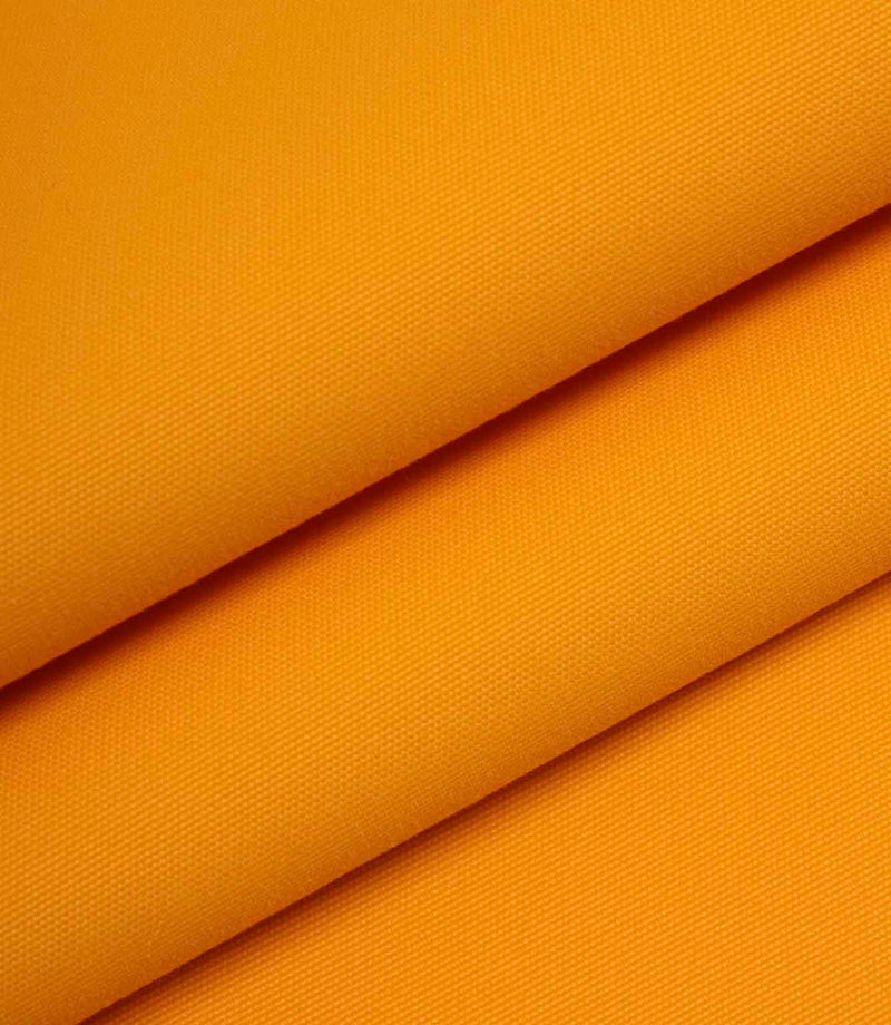 Orange woven fabric folded to show thickness, structure, and smooth surface finish.