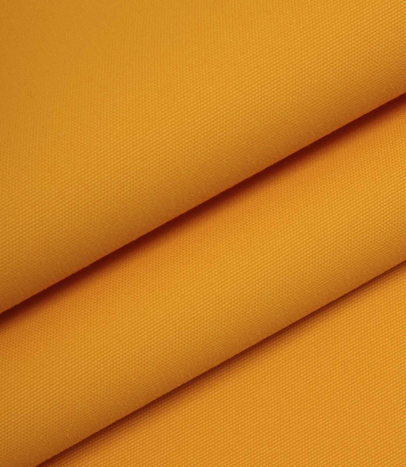 Orange woven fabric folded to show thickness, structure, and smooth surface finish.