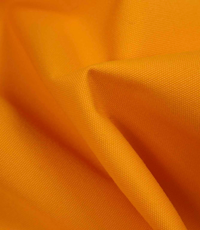Softly draped orange fabric highlighting flexibility, texture, and light surface sheen.